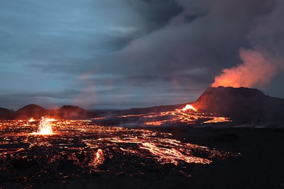 Volcano and lava field against a stormy sky