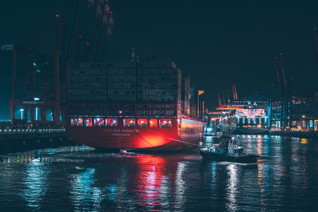 red and white boat on water during night time