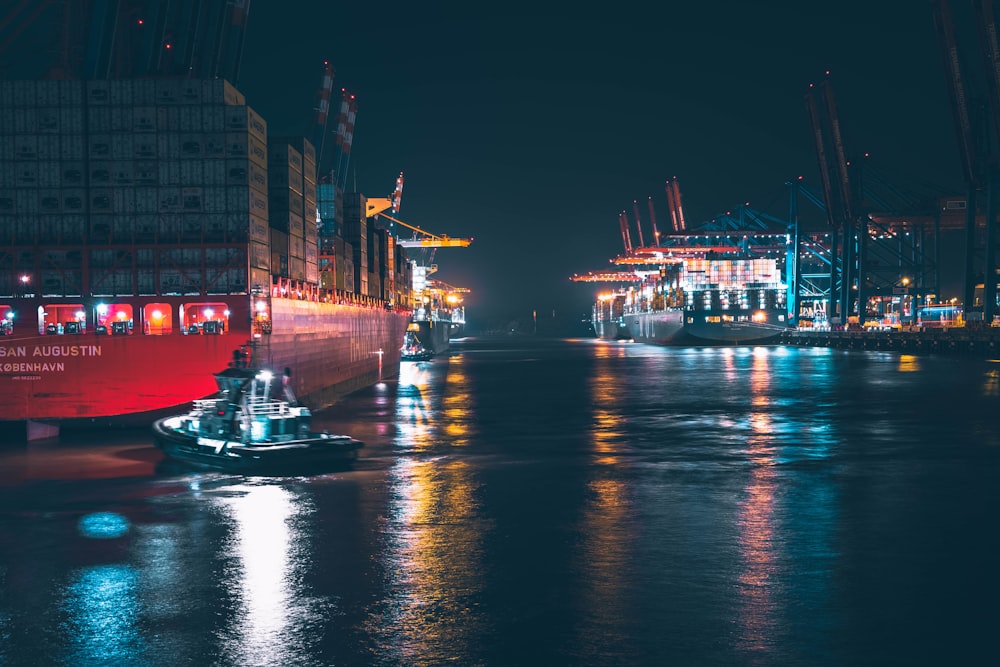 red and white boat on water during night time