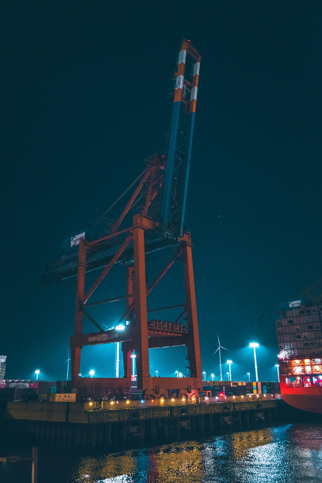 orange and blue tower crane during night time