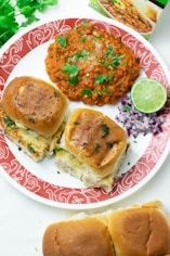a red and white plate topped with sandwiches and other food