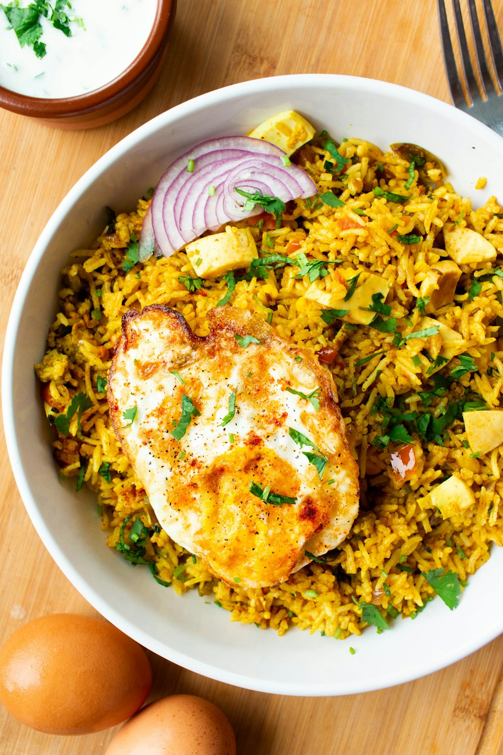 a white bowl filled with rice and chicken