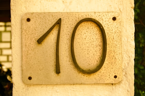 a yellow plaque with a red number 10 against a yellow surface