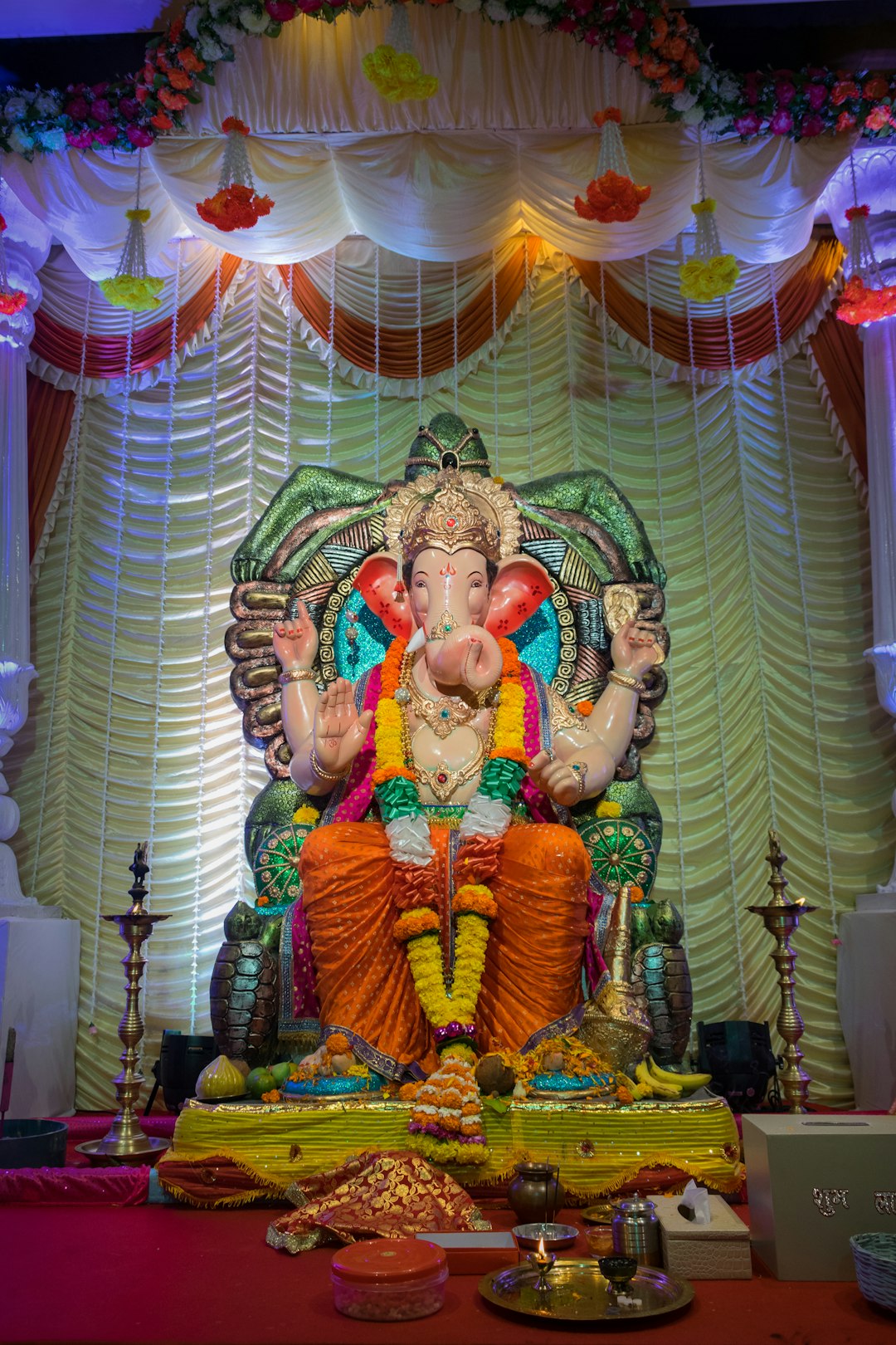 hindu deity figurine on green and white textile