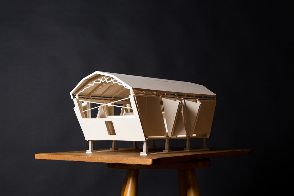 white wooden house on brown wooden table