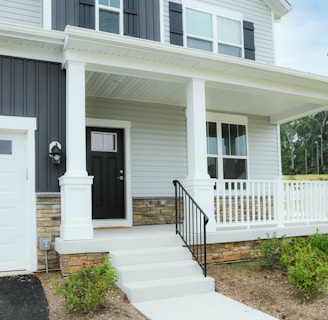 a white house with a black front door