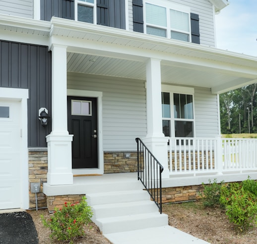 a white house with a black front door