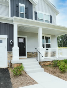 a white house with a black front door