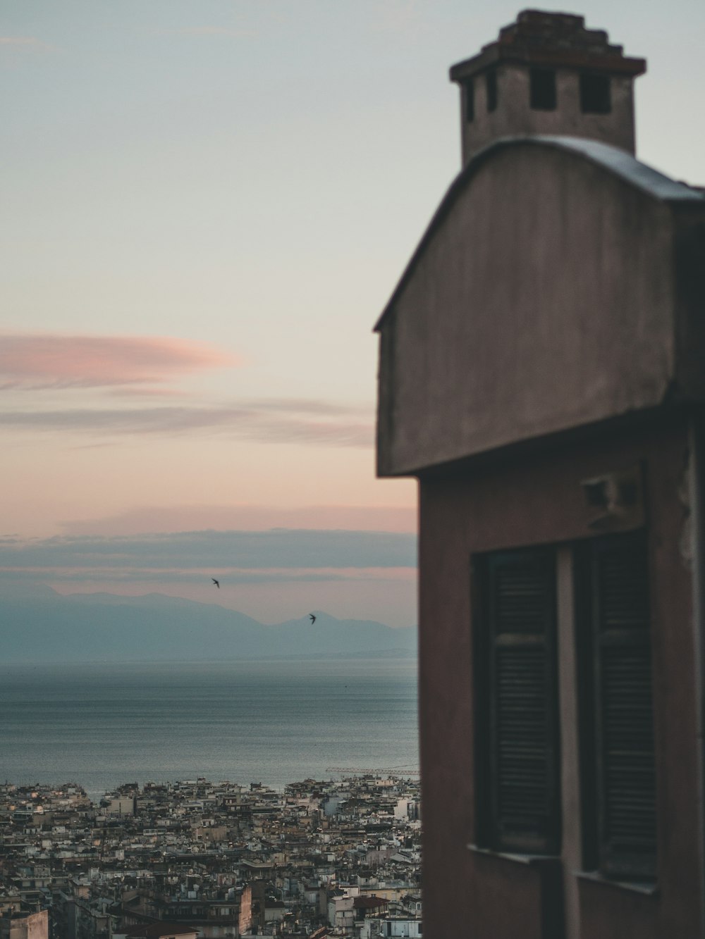 brown wooden house on beach during sunset