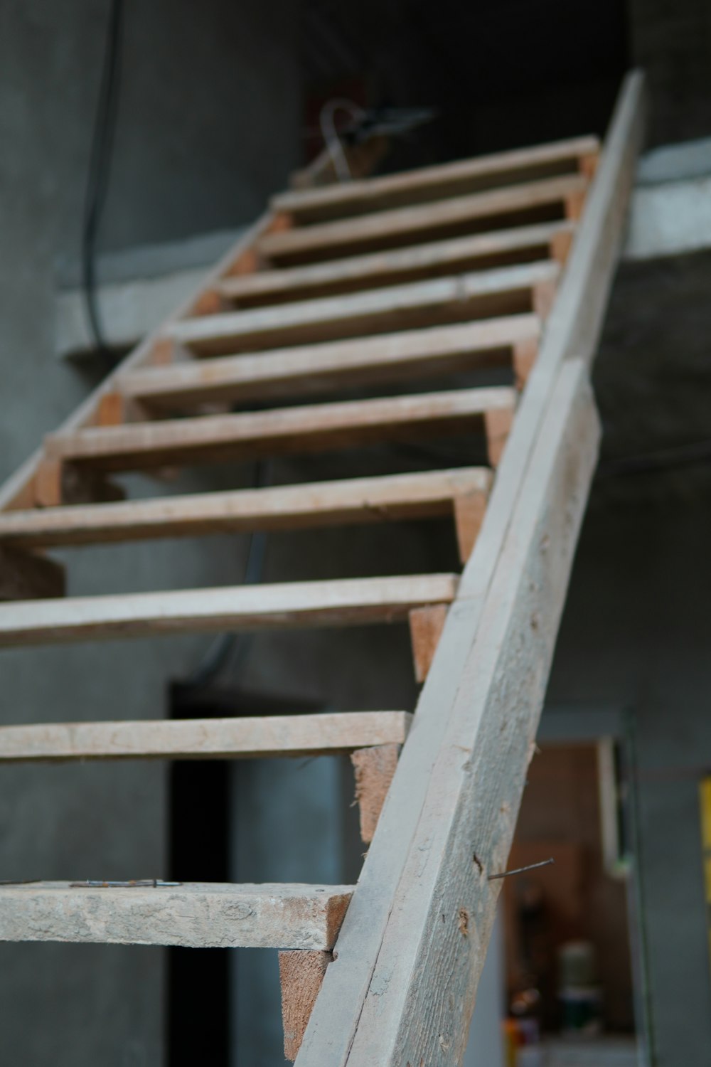 a close up of a wooden ladder in a building