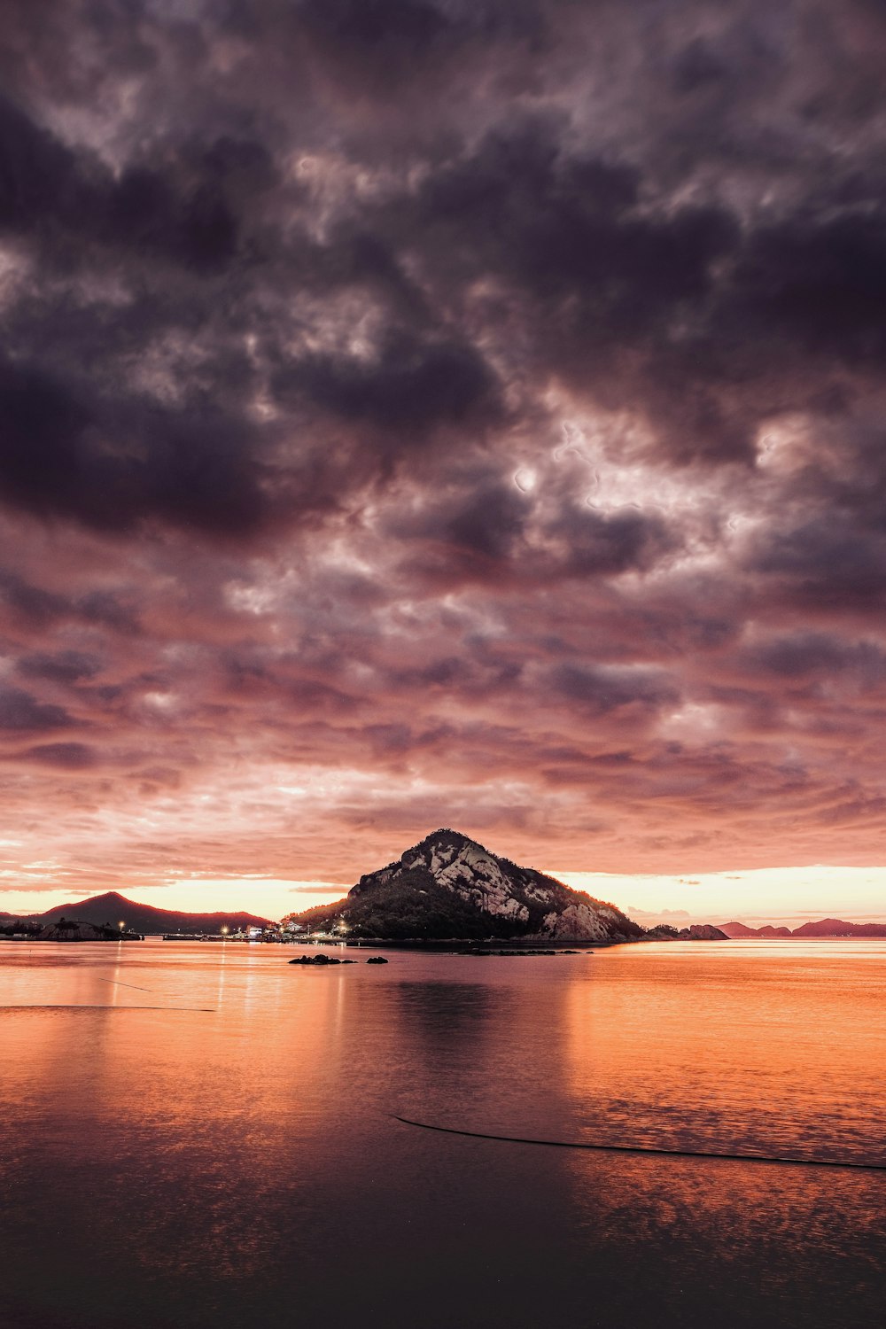 a large body of water under a cloudy sky