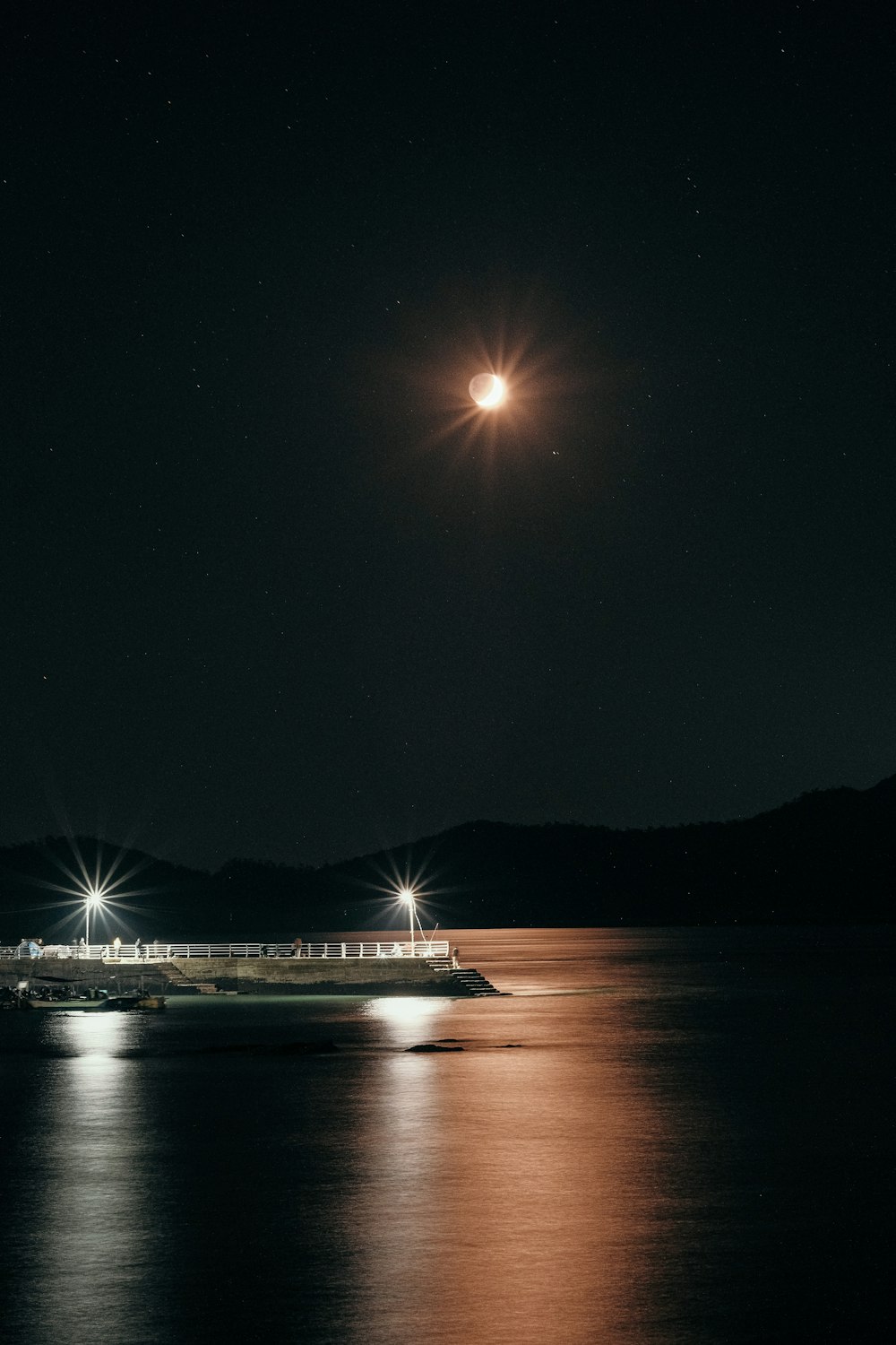 white ship on sea during night time