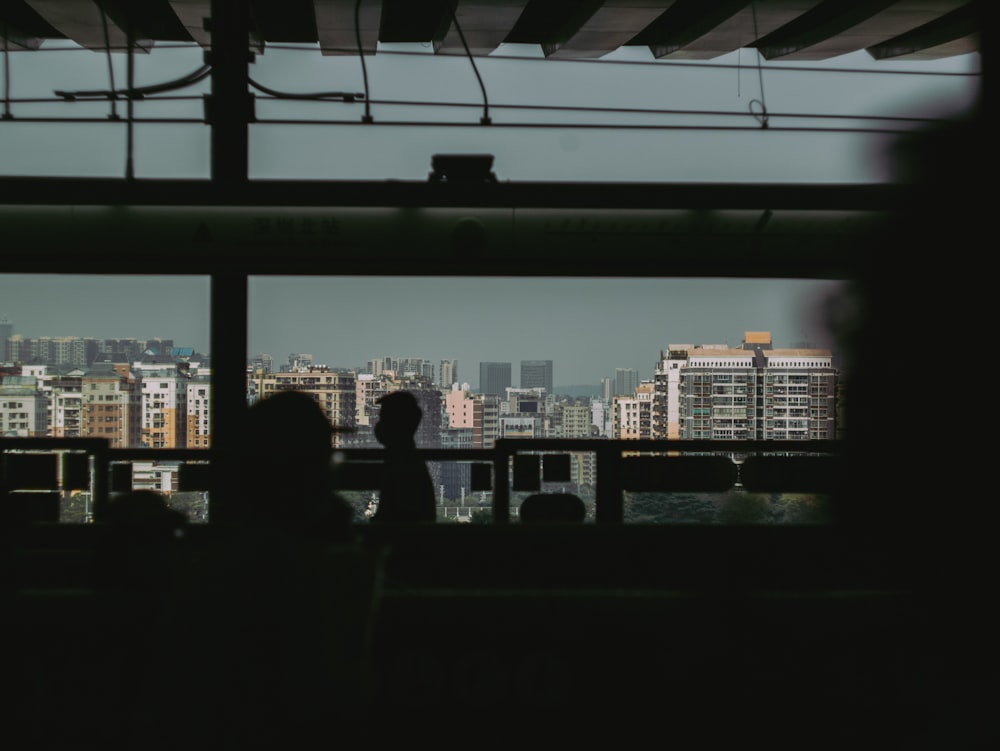 silhouette of people standing on building during sunset