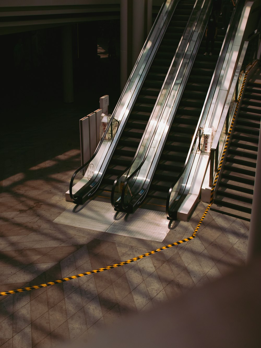 black and silver escalator on gray concrete floor