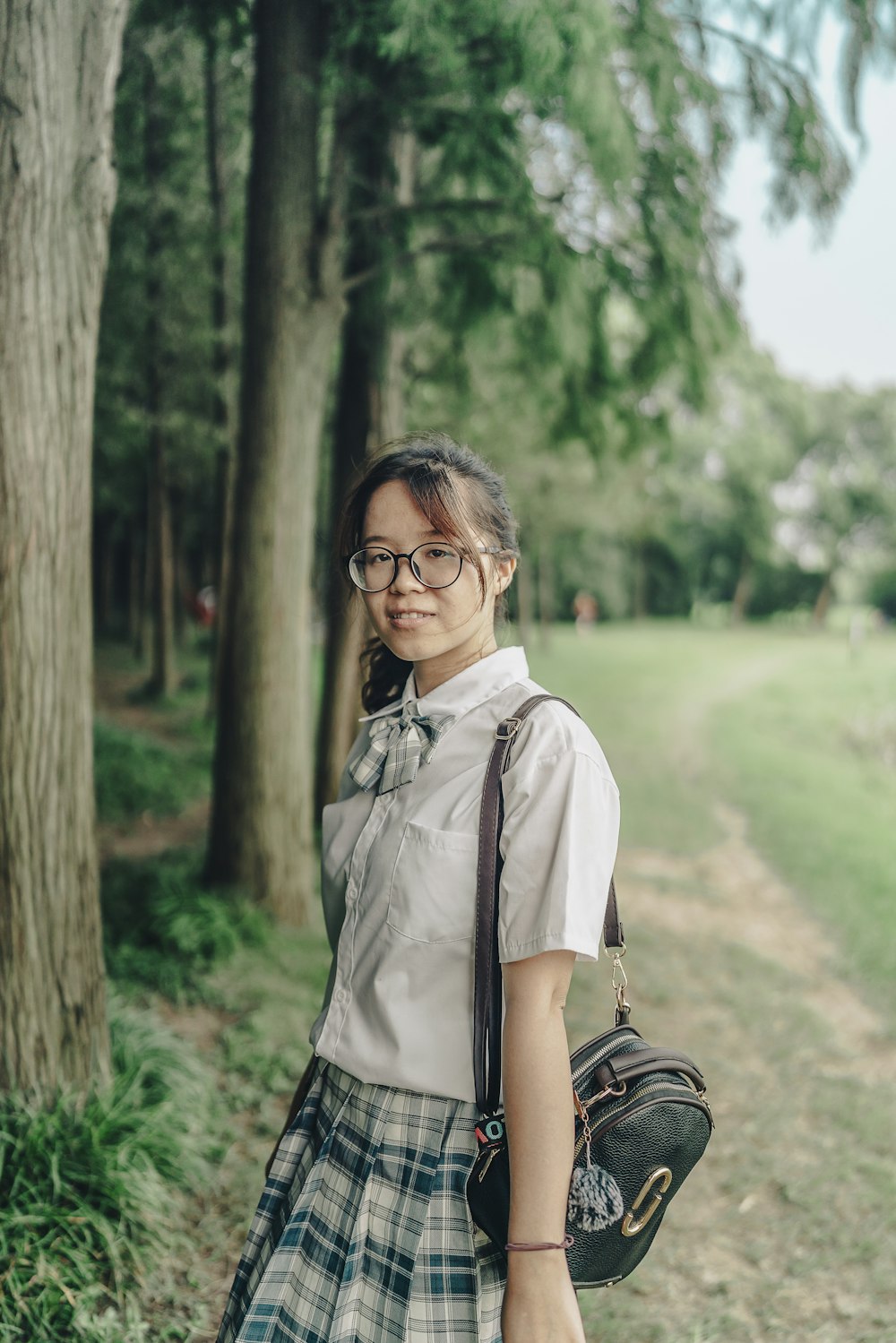 woman in white button up shirt wearing black framed eyeglasses