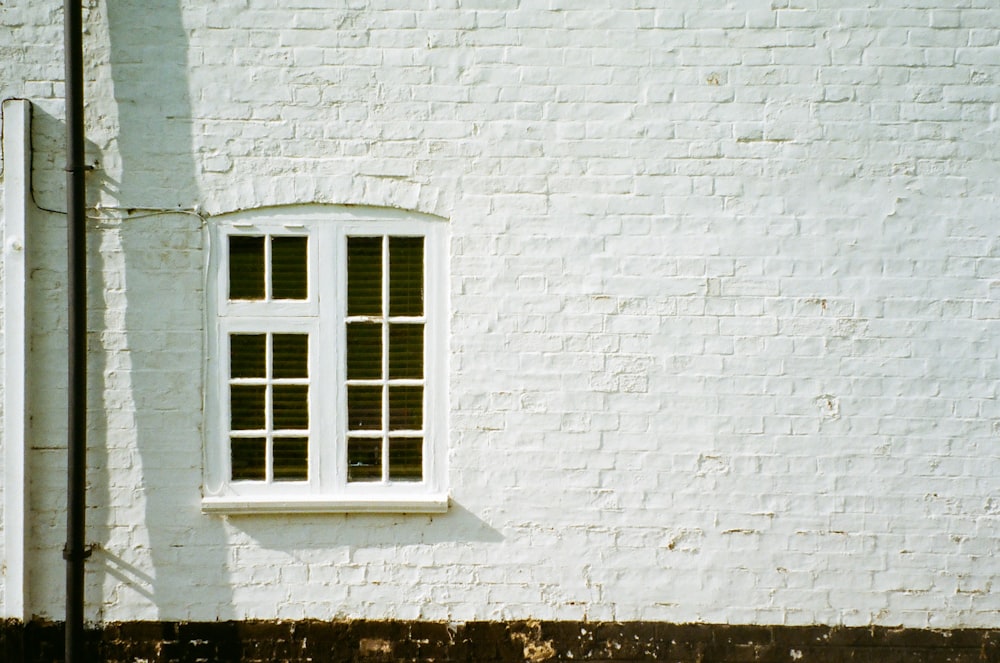 a white brick building with a white window