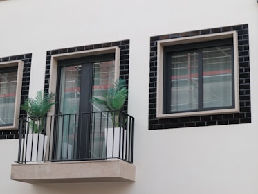 A stylish balcony renovation with modern railings and outdoor furniture.