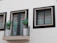 Photo of a modern balcony with a neatly installed dark green safety net.