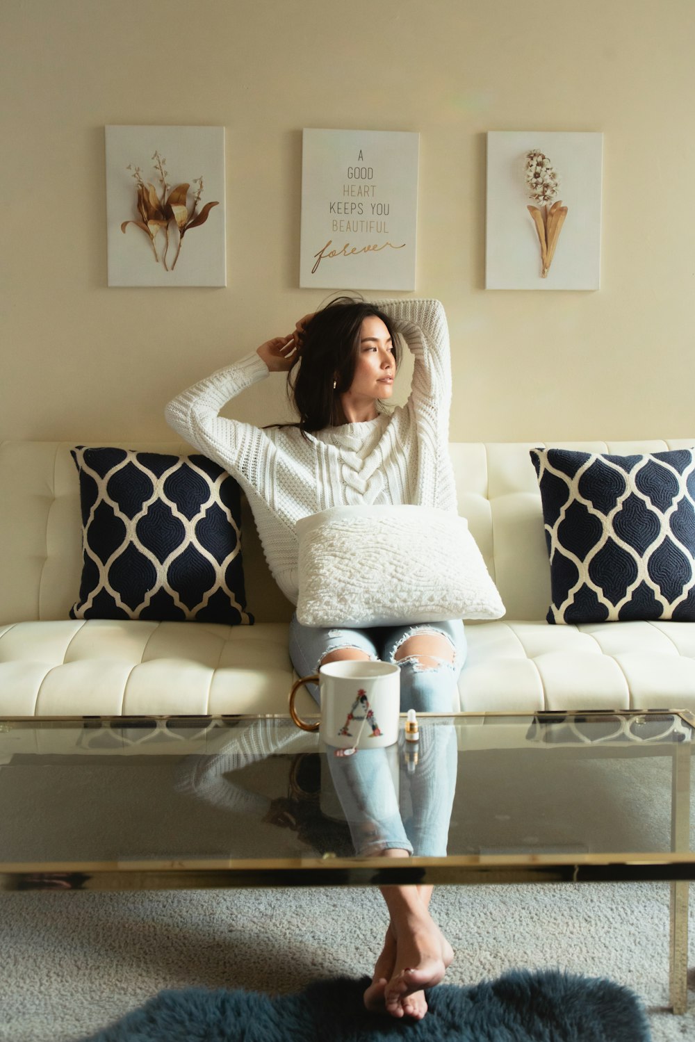 a woman sitting on a couch with a coffee table