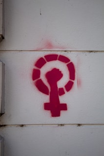 a red question mark on a white wall