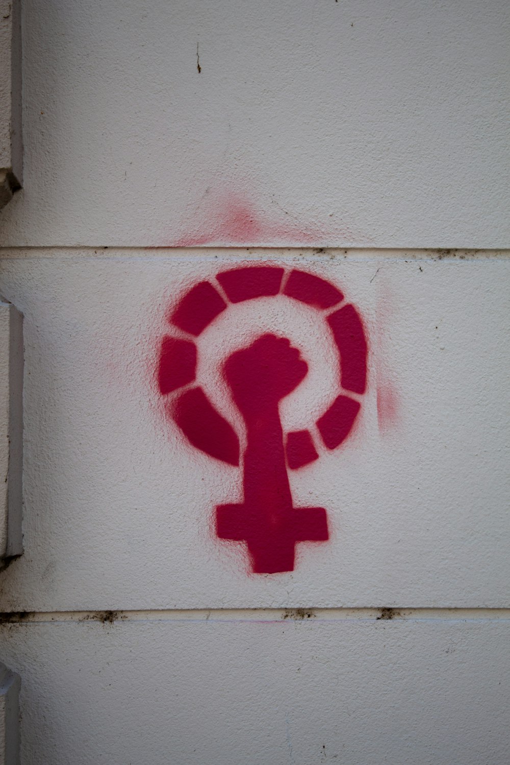 a red question mark on a white wall