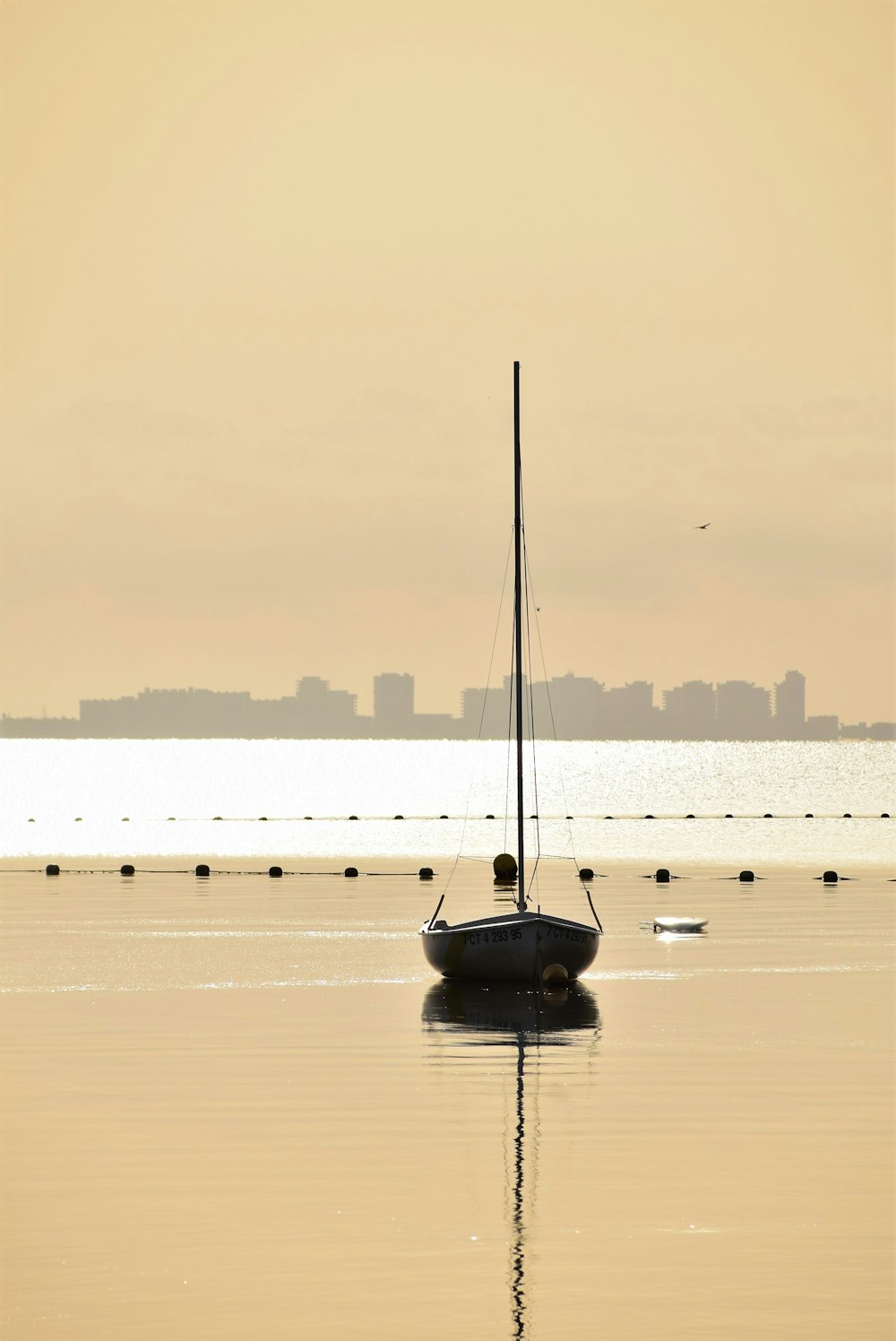 a sailboat floating on top of a body of water