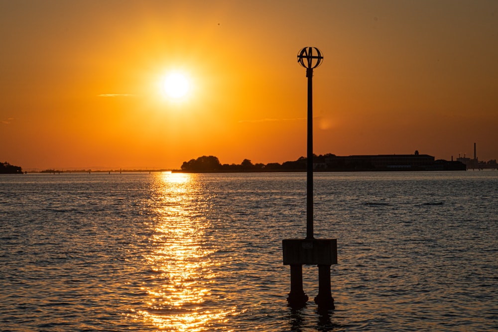 the sun is setting over a body of water