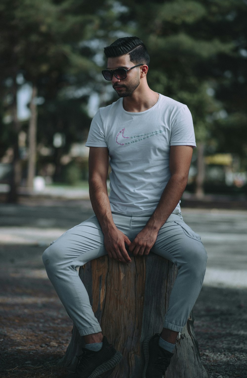 a man sitting on top of a tree stump