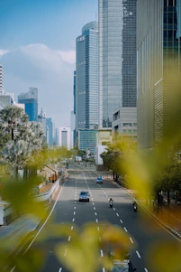 a view of a city street with tall buildings