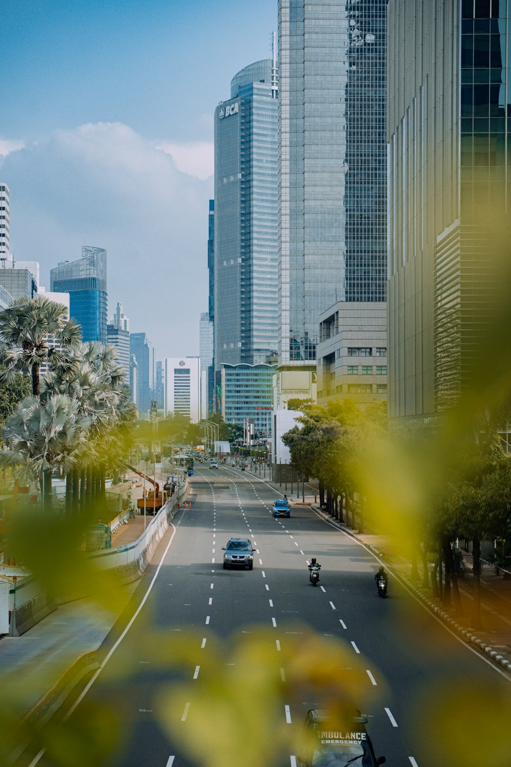 a view of a city street with tall buildings