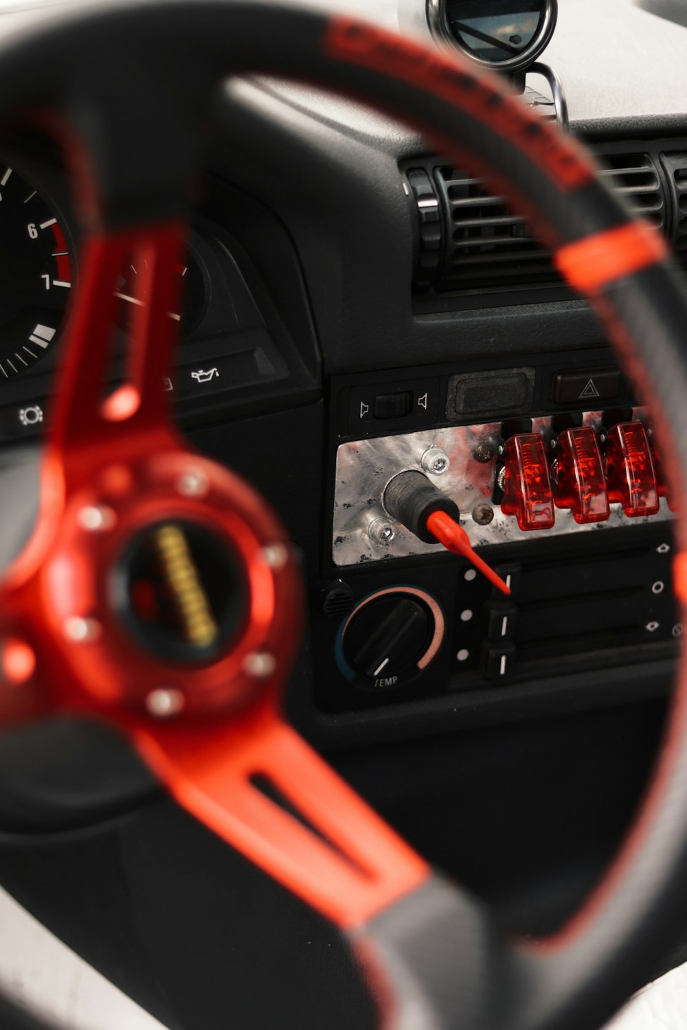 a car dashboard with a steering wheel and gauges