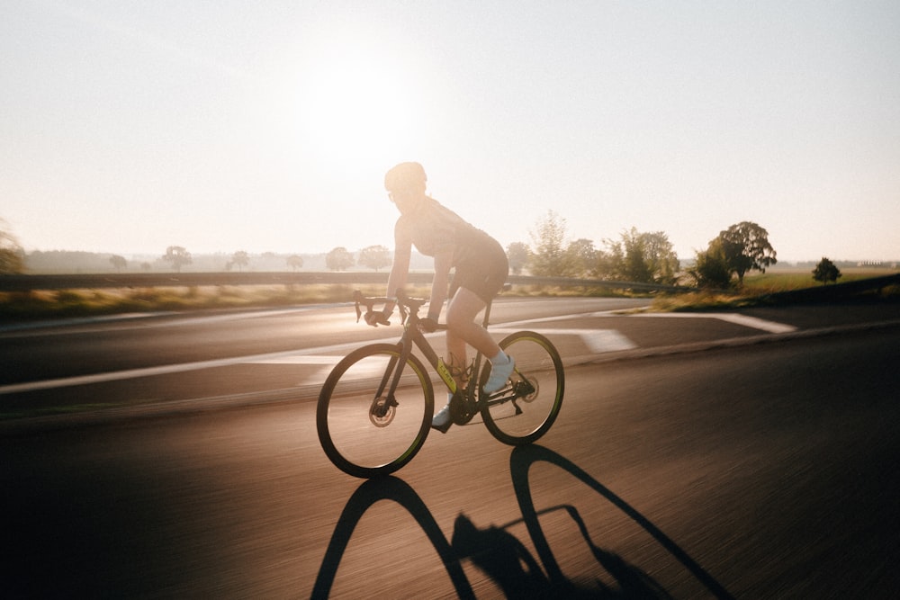 man riding bicycle on road during daytime