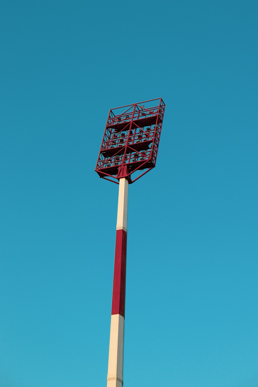 a tall red and white pole with a sign on top