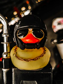 Colorful rubber ducky earrings sparkling under neon lights