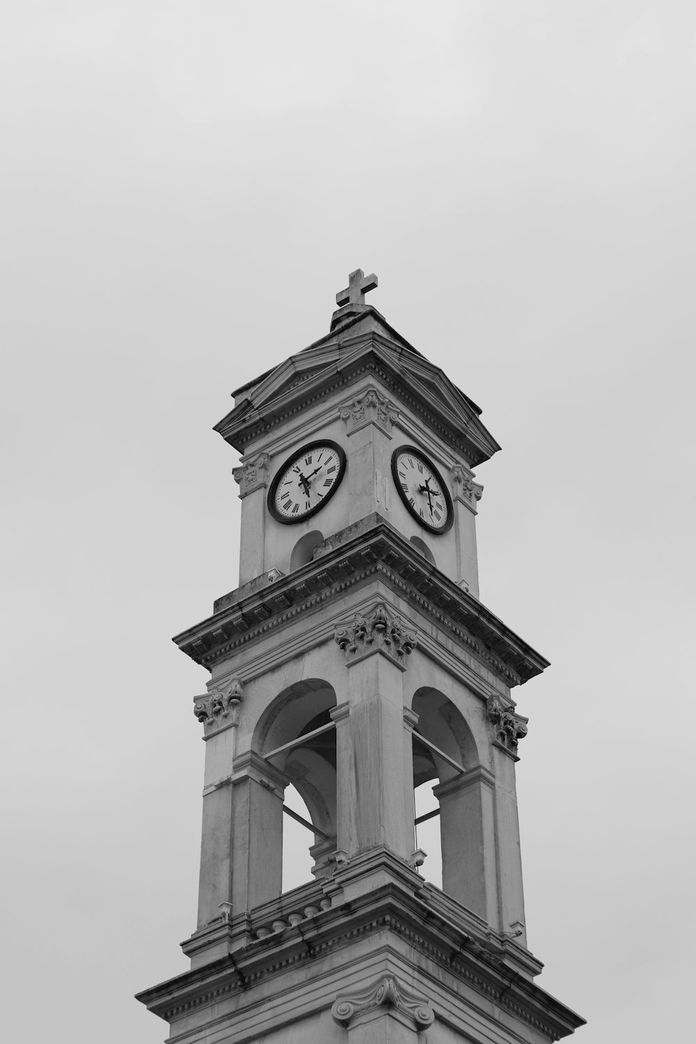 a tall clock tower with a clock on each of it's sides