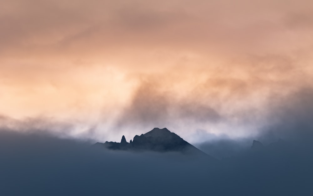 black mountain under white clouds