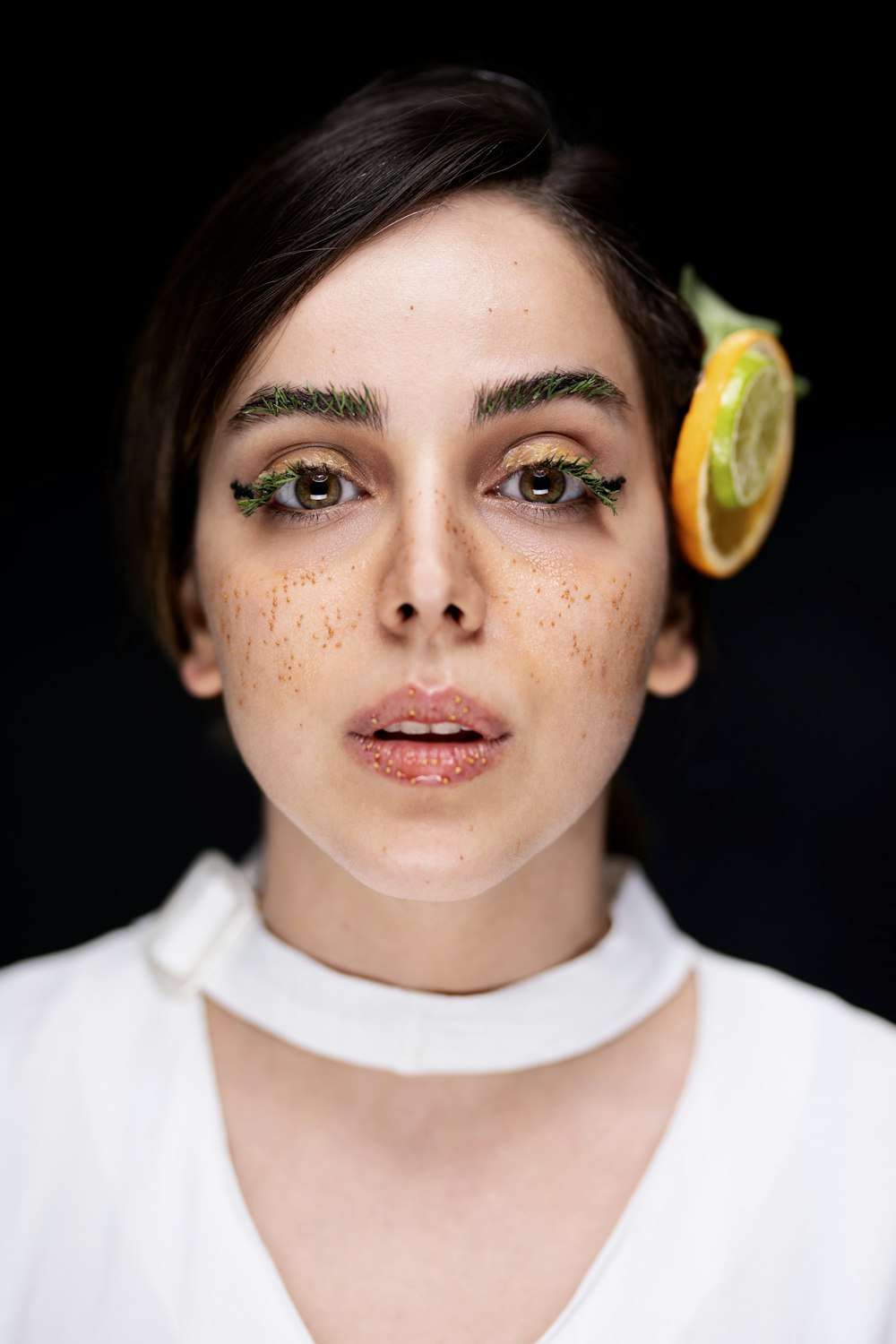 a woman with a slice of orange on her head