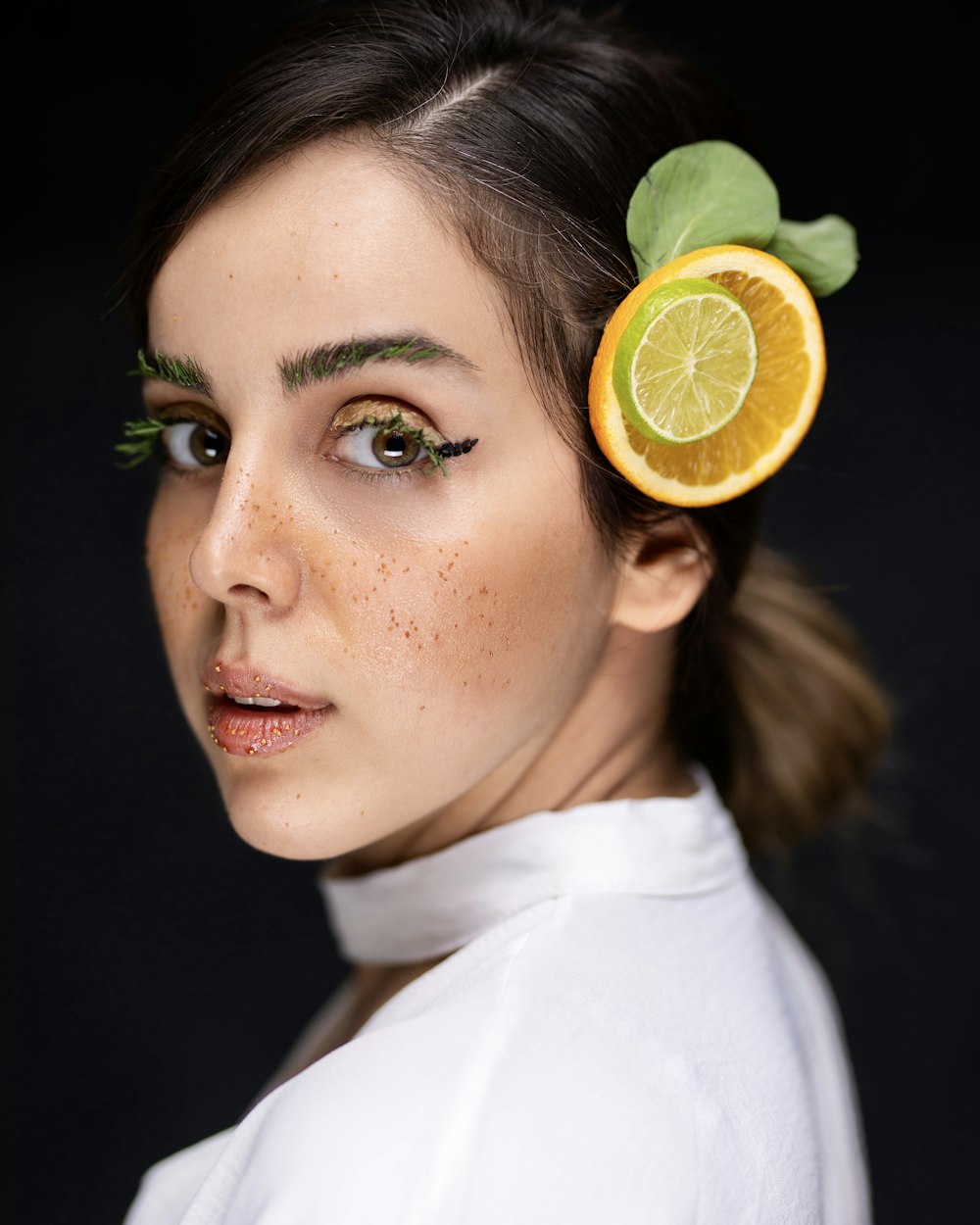 a woman with a fruit in her hair