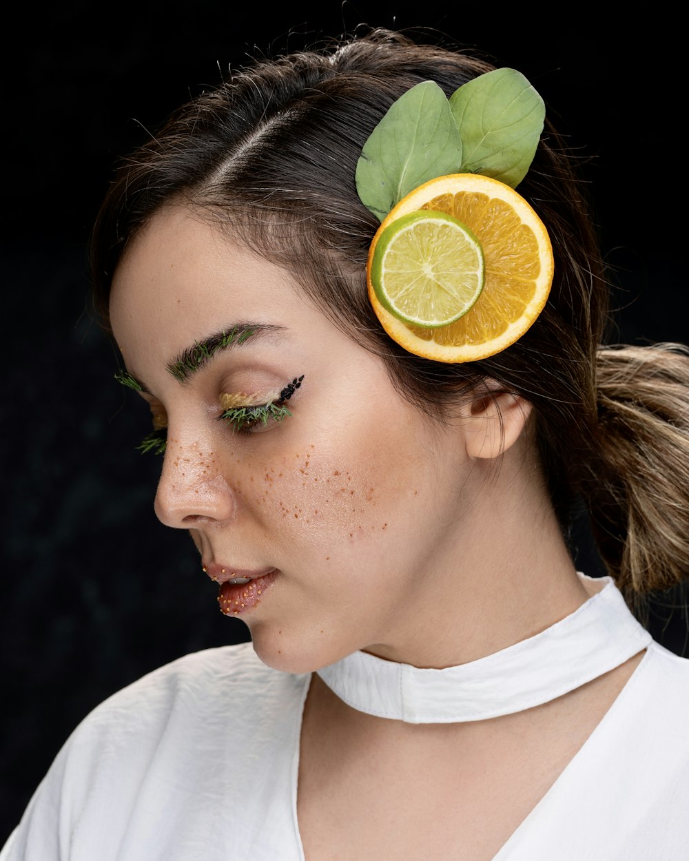 a woman with a slice of orange in her hair