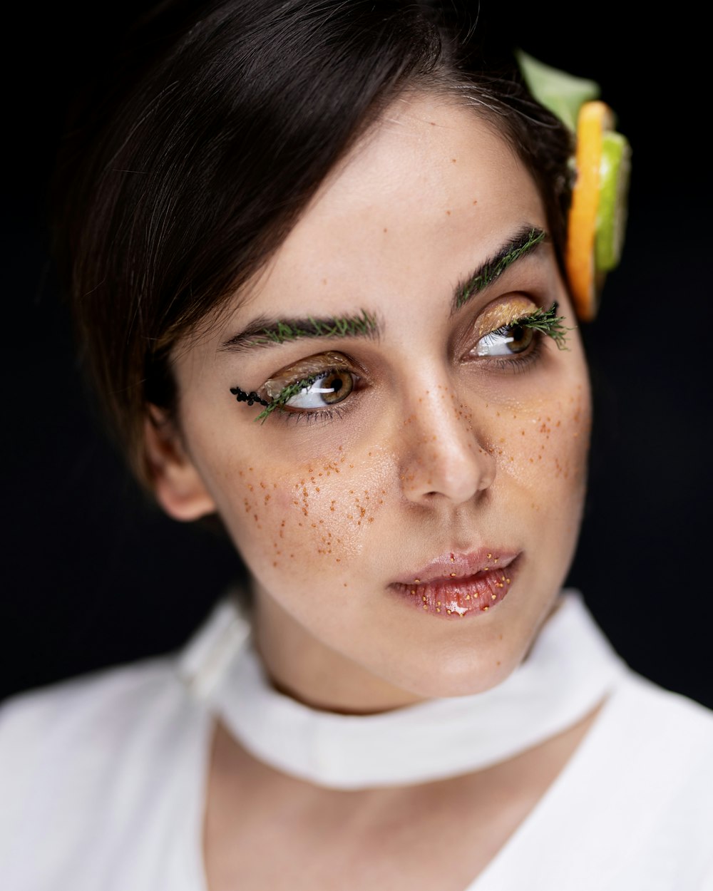 a woman with freckles and a flower in her hair