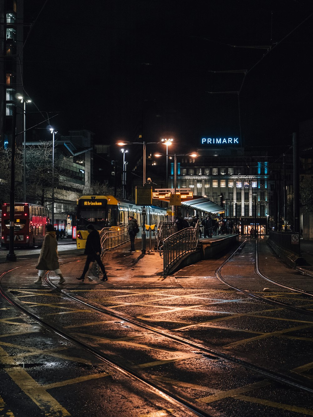 people walking on sidewalk during night time