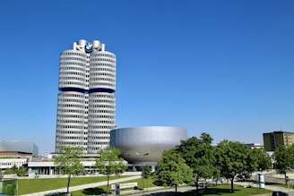 a tall building with a circular entrance in front of it