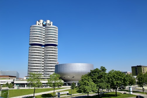 a tall building with a circular entrance in front of it