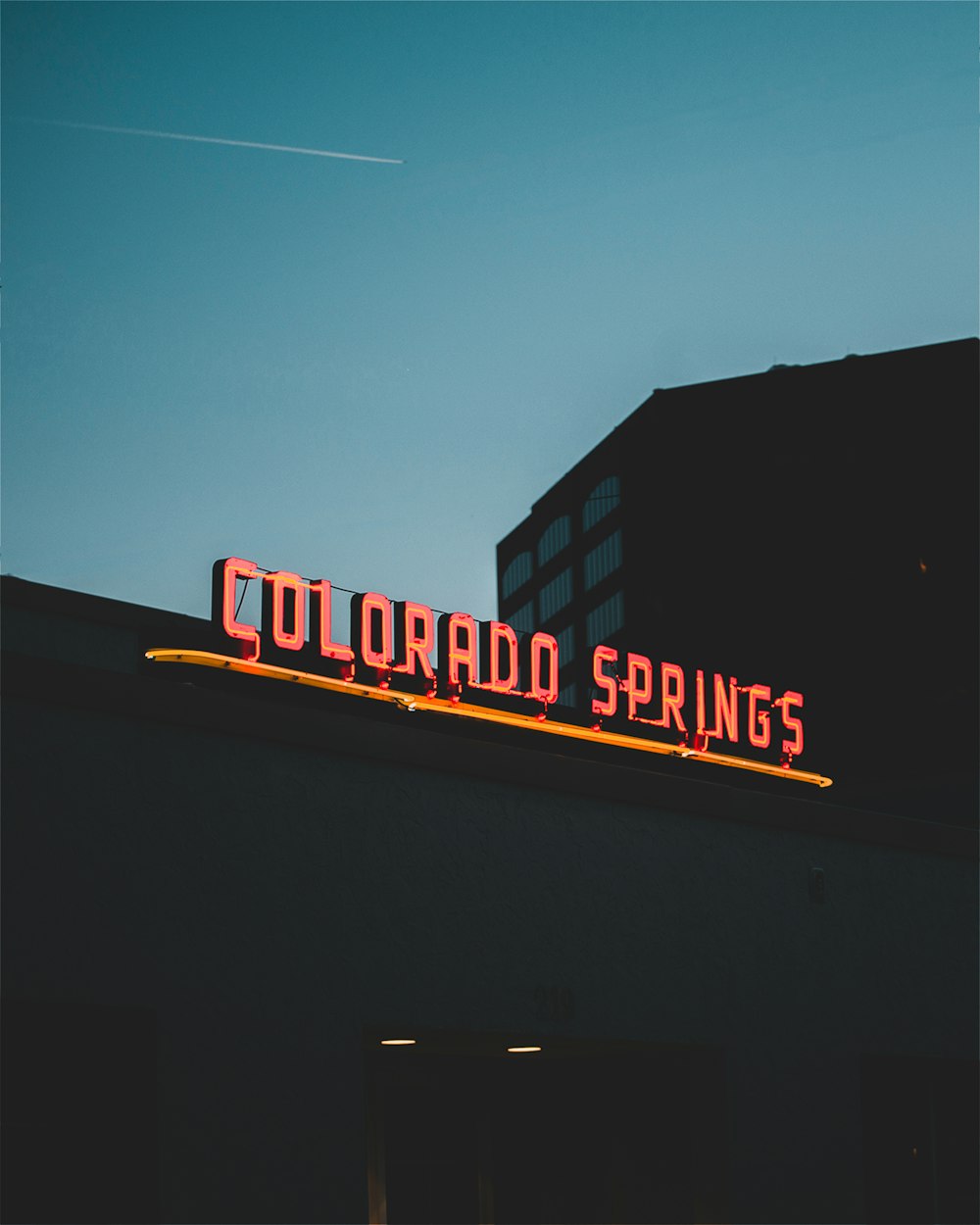 a neon sign on the side of a building