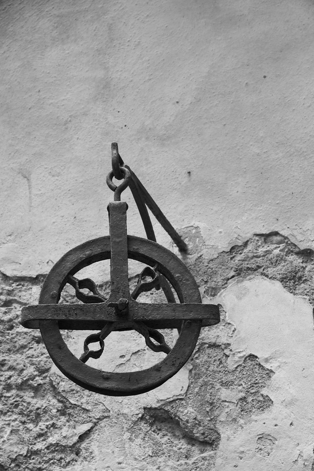 black metal wheel on white concrete wall