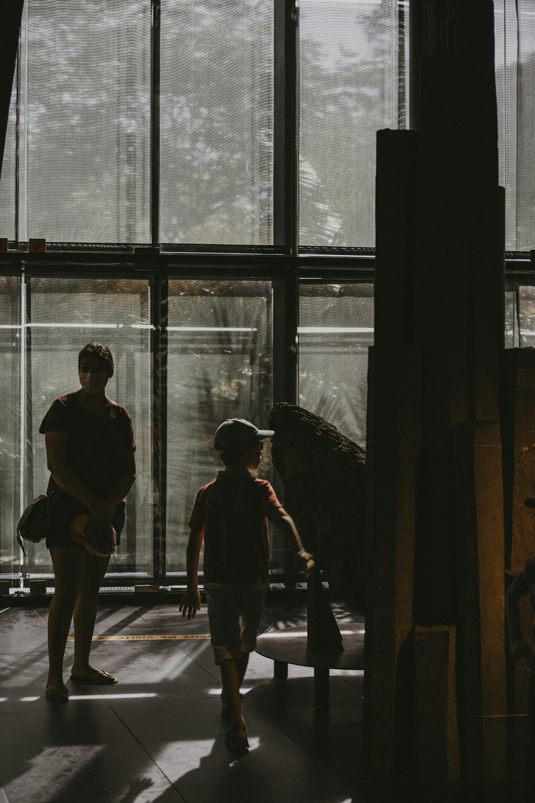 man and woman standing near window