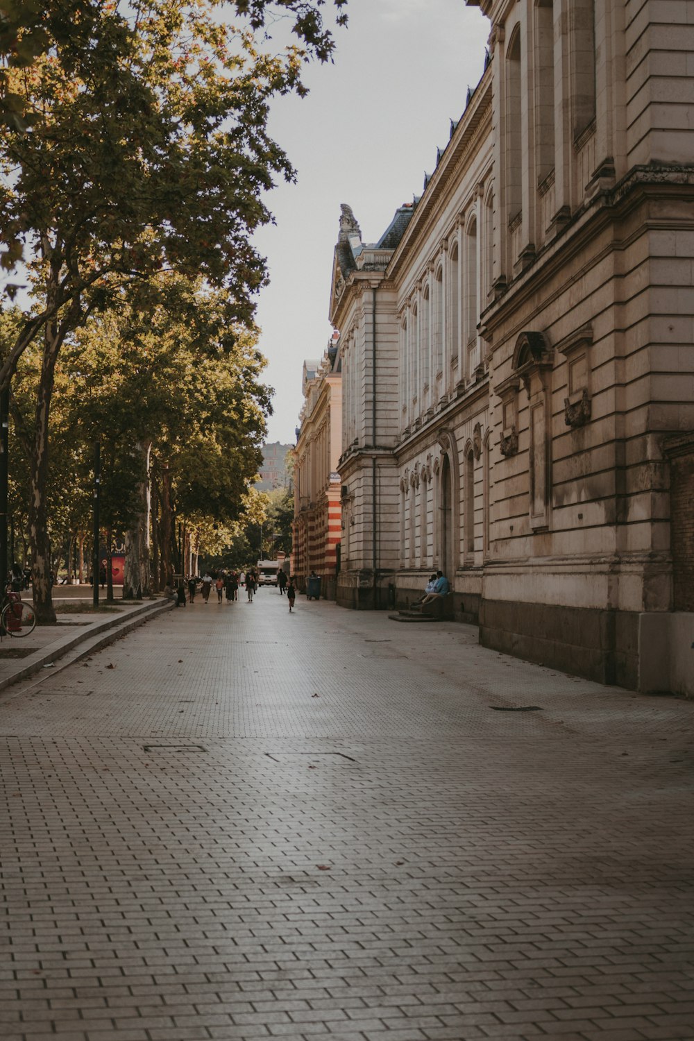 people walking on sidewalk near building during daytime