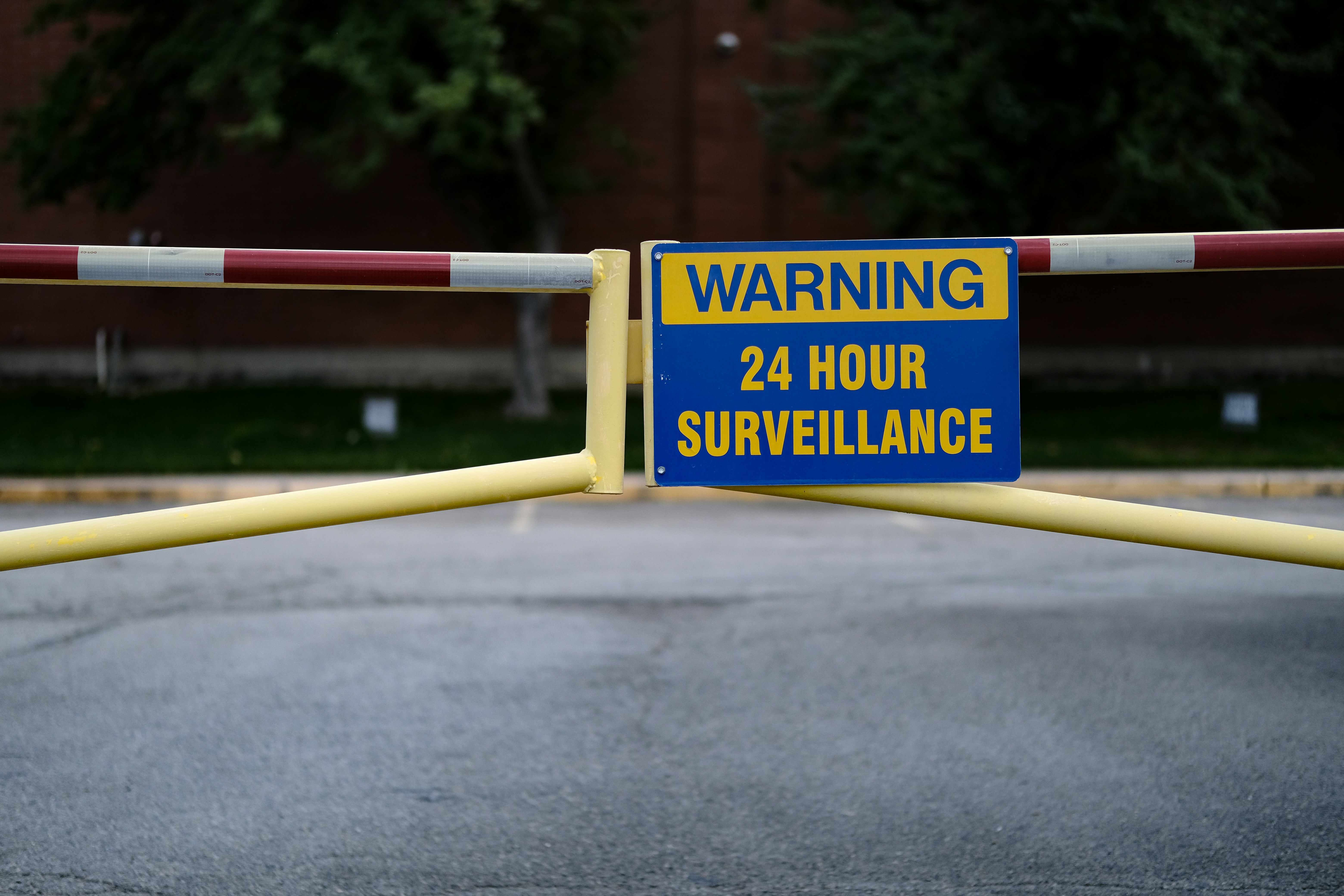 a warning sign is posted on a barricade