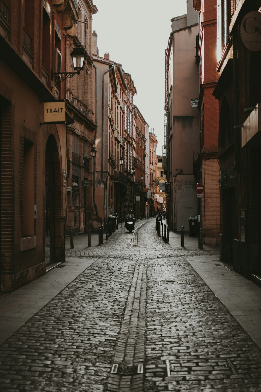 people walking on street between buildings during daytime