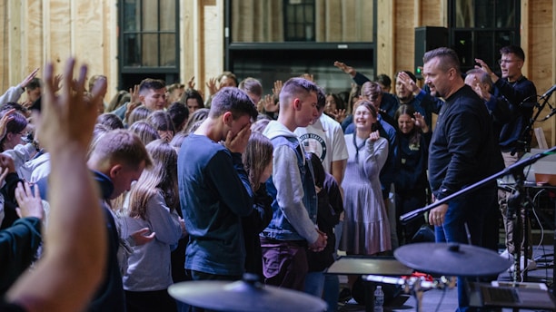 a group of people standing in front of a microphone